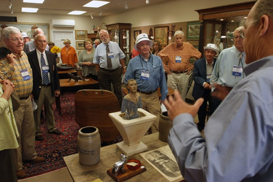 Rick Wolf ’77 speaks to Five-Star Generals and their guests at his antique shop on Washington Street.